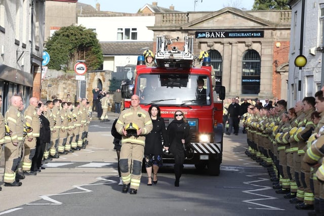 Streets lined in honour of Corby firefighter Hilmi Say as his family walk in front of the turntable ladder hearse