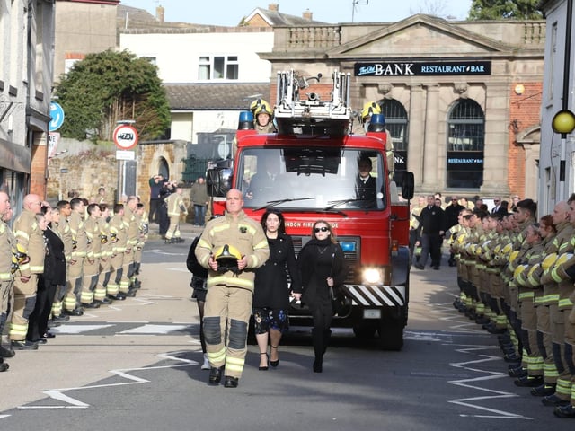 Streets lined in honour of Corby firefighter Hilmi Say as his family walk in front of the turntable ladder hearse