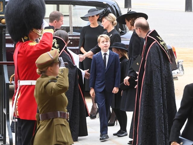 Prince George, Meghan, Duchess of Sussex and Sophie, Countess of Wessex walk into the Abbey