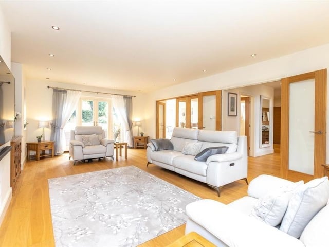 This modern family home is in a picturesque village and shares its boundary with a church.