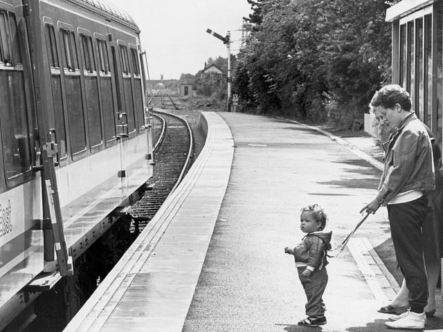 It's all over. A toddler waves goodbye to the last train out of Corby in 1990