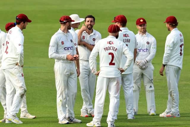 Ben Sanderson celebrates with his Northants team-mates after taking the wicket of Daniel Bell-Drummond