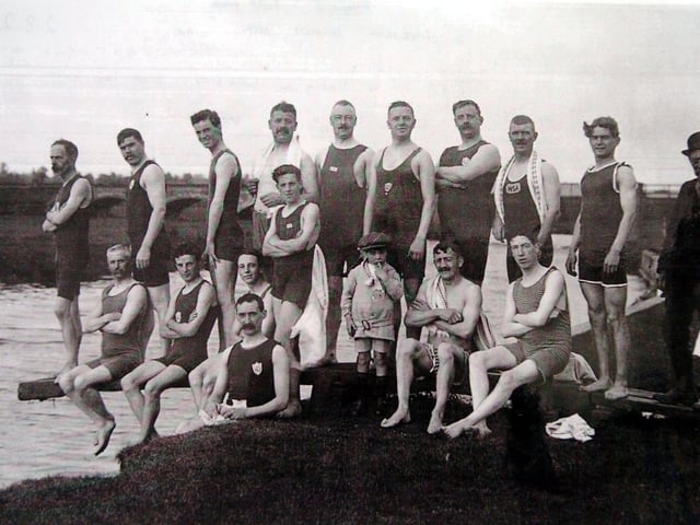 Members of Wellingborough Swimming Club C1900 pose on the diving board at the Embankment