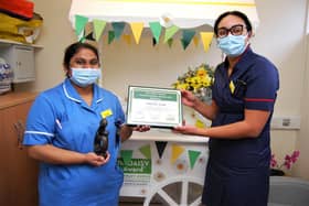 Registered nurse Neethu John receives her award from Gen Surg Matron Hannah Graziano