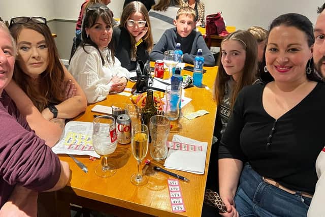 Photo of Age UK Northamptonshire employees Mark, Wendie and Amey with their families at the Virtual Race Night