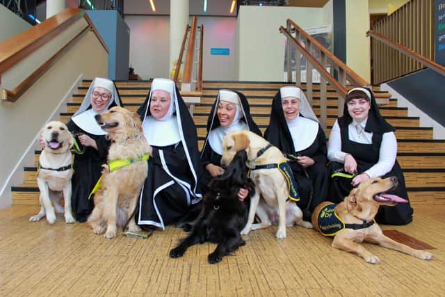 Nuns from Sister Act The Musical with guide dog puppies