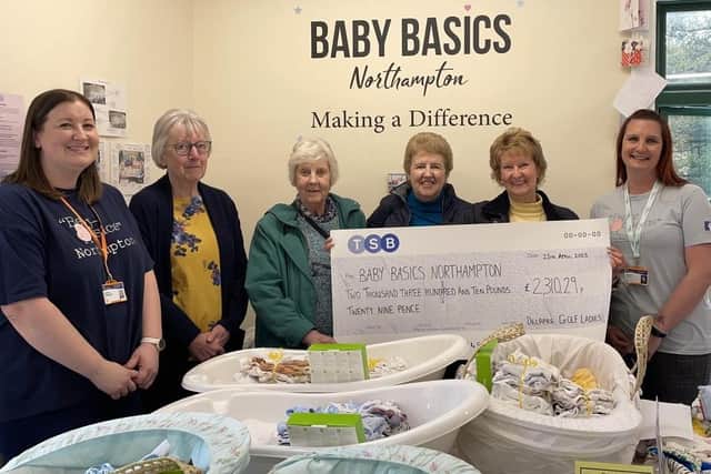 Theresa and some of the Delapre Golf ladies team handing over the cheque to the Baby Basics Northampton team