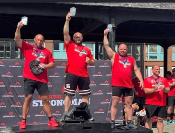 James Merry (center) celebrates his victory as England’s Strongest Master 40+ with fellow podium finishers.
