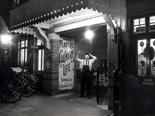 Richard Ashby lights the restored gas lighting at Rushden train station in November 1991