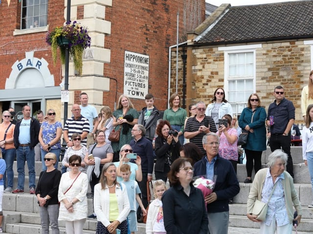 Standing in honour of the late Queen