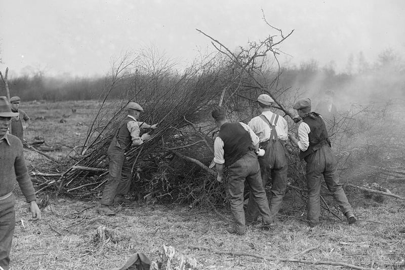 People are pictured burning brushwood at a Ministry of Labour training camp, Kettering in 1929.