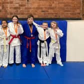 Shudan Judo Club members with their medals and AJA National Squad badges