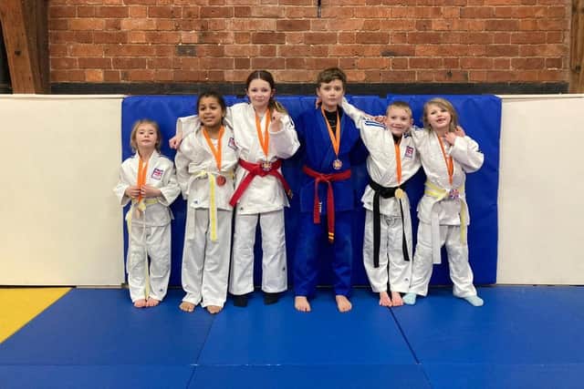 Shudan Judo Club members with their medals and AJA National Squad badges