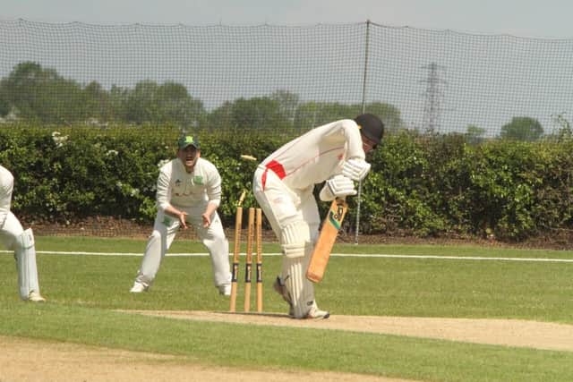The bails are off as a batsman is bowled in Brigstock's win at Overstone