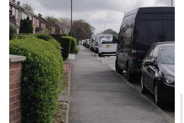 Cars parked nose-to-bumper along Scott Road, which is just yards from the station