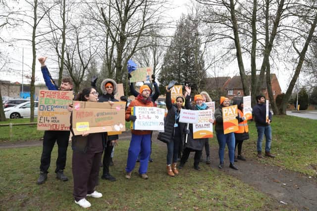 Doctors wave at passing motorists