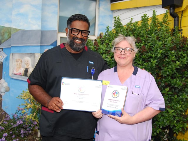 Prof Ganesh Baliah presents healthcare assistant Toni Hancox with her award