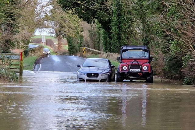 Bill Clarke offers help to a motorist stuck in the flood