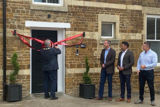 Wellingborough Town Council mayor Jonathan Ekins cutting the ribbon at the care home opening