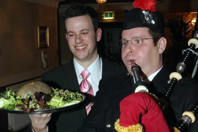 Burns Night at Hunting Lodge in 2006. Tim Meeks carrying the haggis and piper Alan Stewart.
