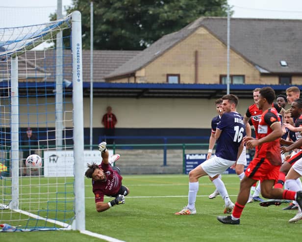 Andrew Oluwabori heads home Kettering Town's late equaliser in the 2-2 draw at Buxton. Pictures by Peter Short