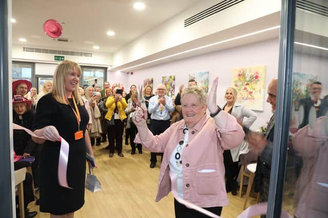 Glennis Hooper cuts the ribbon on the Crazy Hats Lounge at Kettering General Hospital - the charity's final major project completed in 2023
