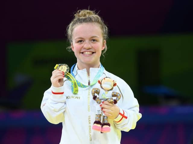 A beaming Maisie Summers-Newton shows off her Commonwealth Games gold medal