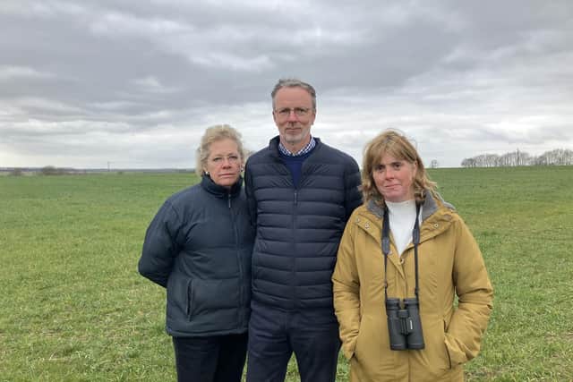 Objectors to the plans stood on the field that could be converted into a solar farm. (left to right- Sylvia Prestwich, Iain Scotland, Julia Fletcher) (Image: Nadia Lincoln LDRS)
