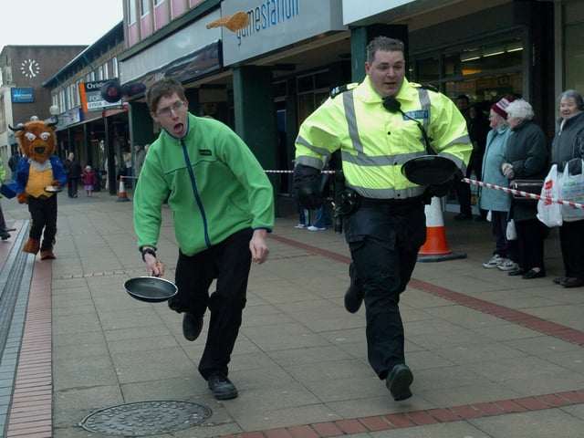 Corby Town centre pancake race race winner Amos Ballard crosses the line ahead of Stephen Crook in the final 2006