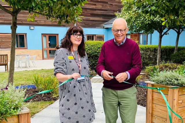 Berrywood chaplain Odette Douglas and Daniel Tabor Chair of the NIFF cut the ribbon