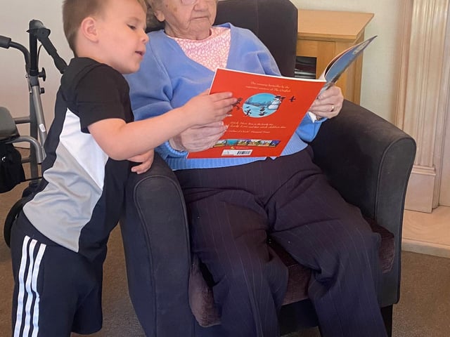Residents enjoying reading with the children