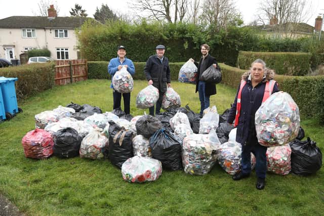 Tinker Williams of Kettering Wombles and last year's haul of aluminium drinks cans/National World