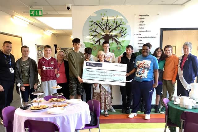 Isebrook 6th Form students present a cheque to Cancer Research representatives.