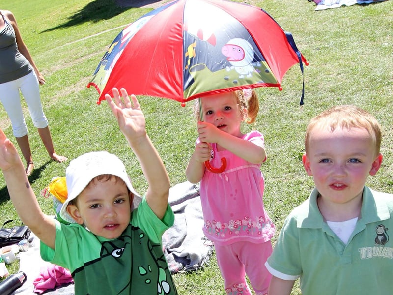 A fun day in 2010. Lewis Ritchie, four, Cagney Ross, four, and Gemma Stewart, three, take shade under the umbrella.