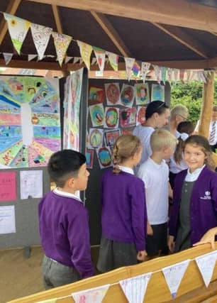 Proud Moments - Students admire their work on display during the 10-Year school celebration