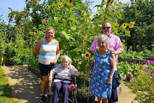 Manager Kate Williams, with residents from Elm Bank Care Home.