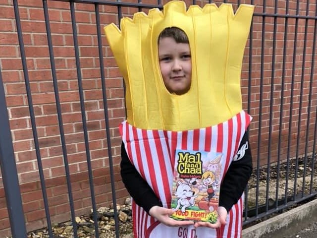 Oscar, age 7, from Kettering as some fries and his food fight book