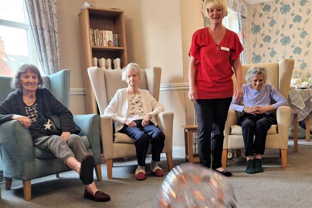 Enjoying a game of armchair football at the dementia cafe at Park House Care Home in Wellingborough