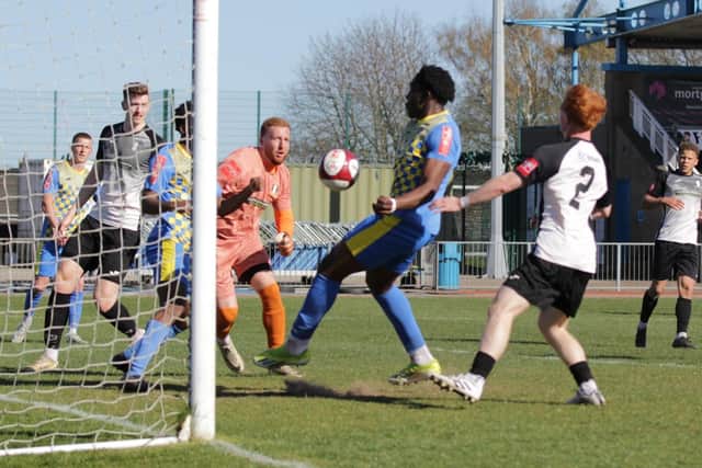 Francesco Obiagwu bundles home Wellingborough Town's second goal at Grantham on Saturday (Picture: Rib Wobb)