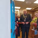 The Mayor of Higham Ferrers cuts the red ribbon.