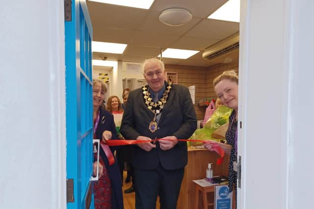 The Mayor of Higham Ferrers cuts the red ribbon.