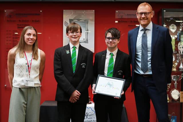KBA students and Principal Richard Shaw are presented the award by Mia Chapman