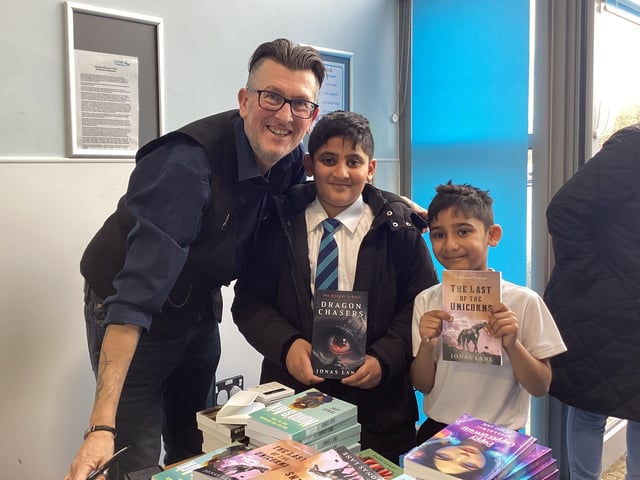 Jonas Lane with some of his new young readers at Great Ouse Primary.