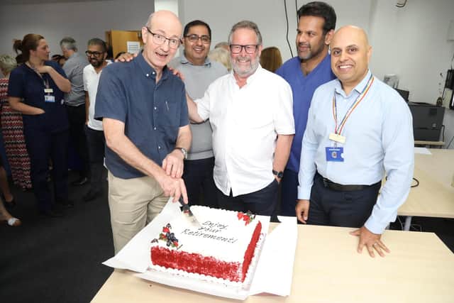Dr Richard Baxter cutting the retirement cake