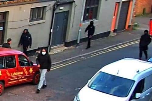 Detectives want to identify these males seen heading for Wellingborough Road, Northampton, on Friday night. Photo: Northamptonshire Police