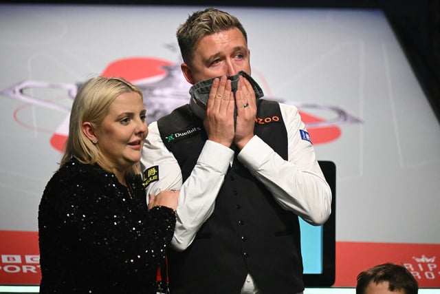 Sofie greets her emotional husband after a hard-fought victory to become world champion.