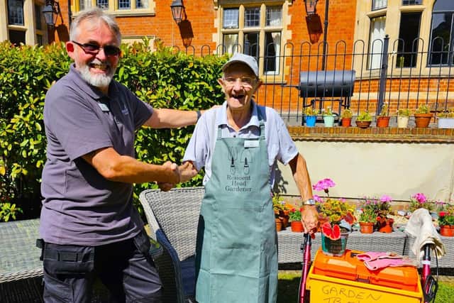 Robert Head of Maintenance presenting Brian with his Apron and Badge
