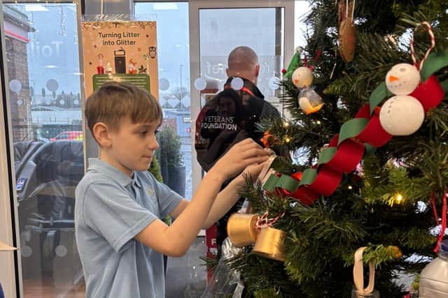Pupil from Avon Park school decorating a Christmas Litter Tree