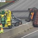 The lorry overturned on the A14 rests on the central reservation/ National Highways