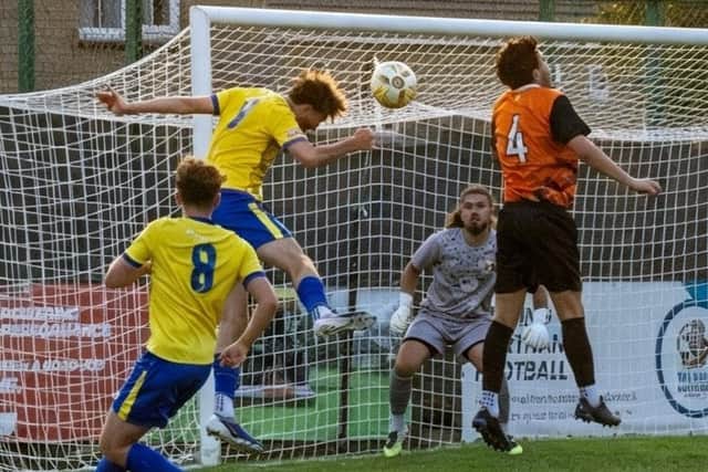 Will Jones heads home Wellingborough Town's opening goal in their win over Rushden & Higham United (Picture: Shaun Frankham)